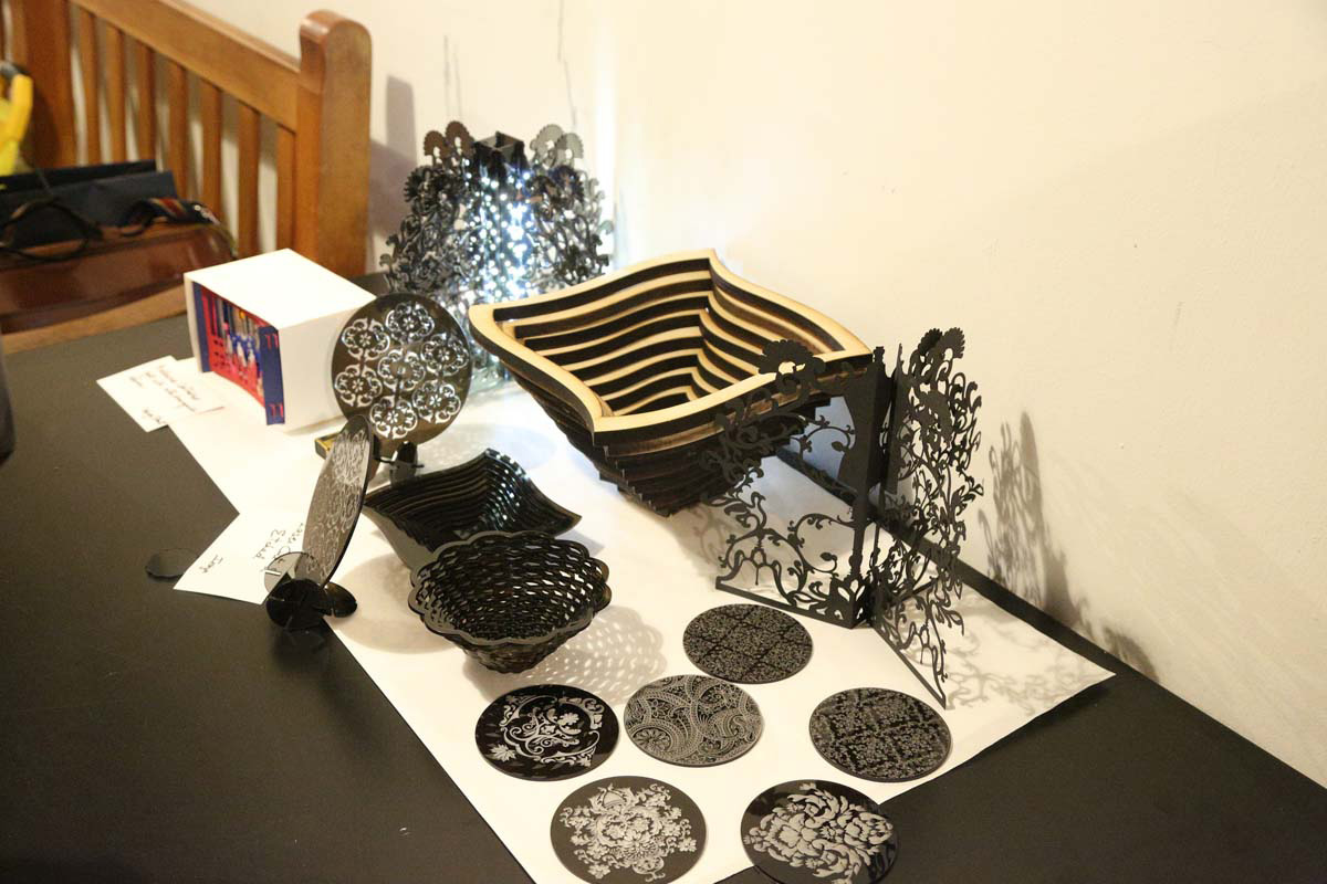 a display of intricately detailed bowls and designs that were laser cut